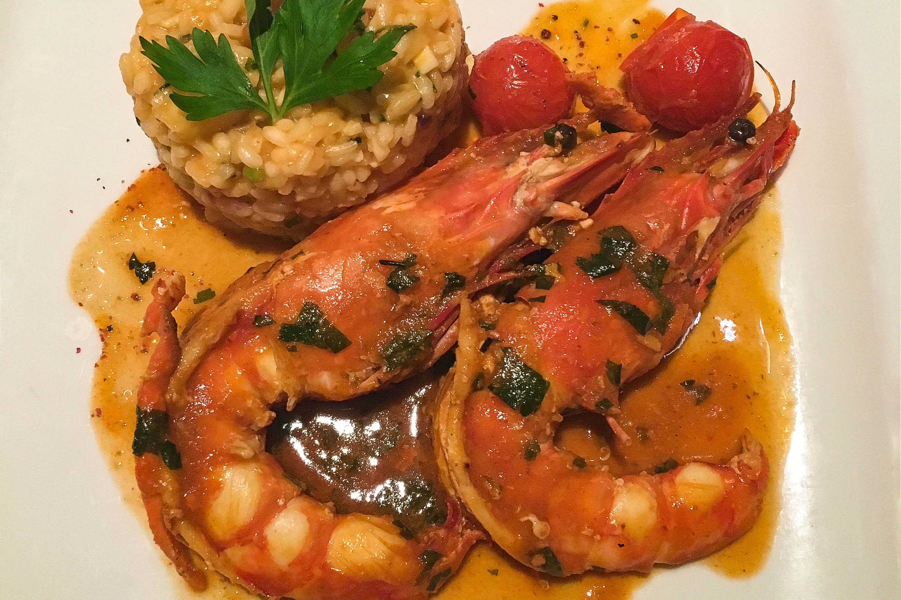 Flambeed tiger prawns with lobster risotto at Lisboa a Noité in Lisbon, Portugal