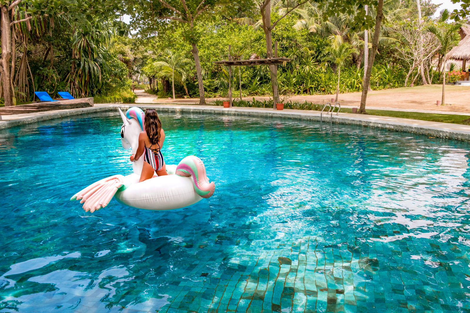 Pulau Joyo island, Indonesia - swimming pool with inflatable unicorn toy