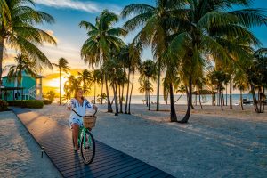 Riding bicycles on the beach at Southern Cross Club, Little Cayman, Cayman Islands