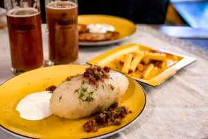 Eating Cepelinai (potato dumplings) at Snekutis in Vilnius, Lithuania